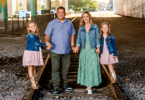 The Johnson Family walking over train tracks representing the hope and healing of chosen's services.