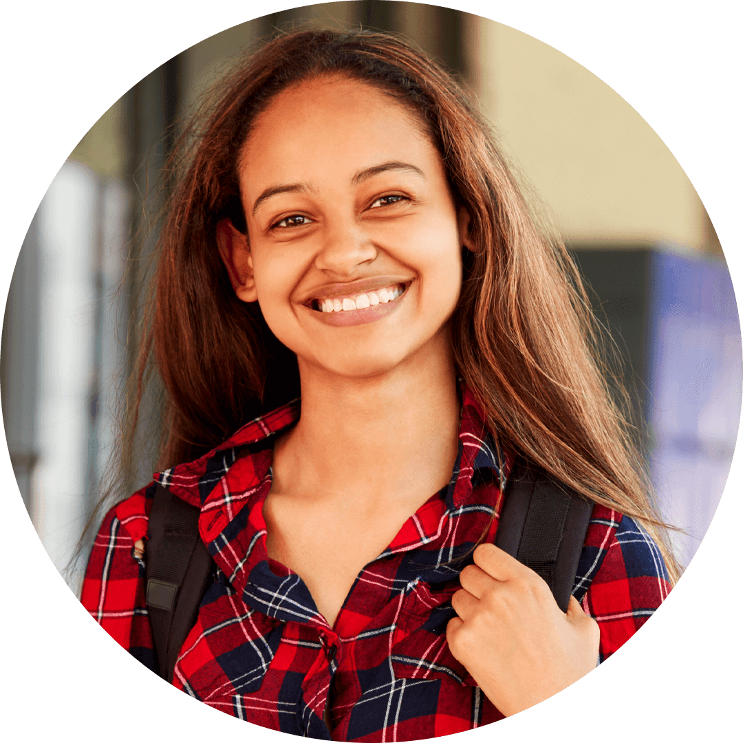 A smiling young woman with long hair wearing a red plaid shirt and a backpack, radiating confidence and positivity.